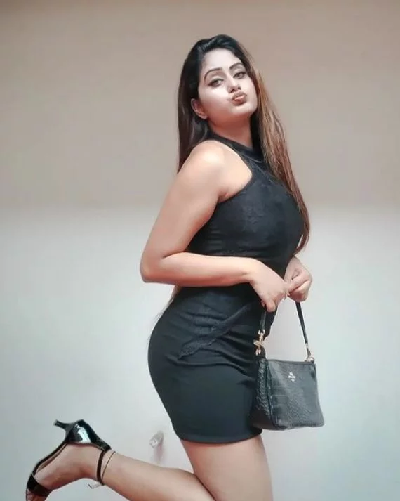 A GIRL 24 YEARS OLD IN BLACK DRESS TAKING HAND BAG IN STANDING POSITION