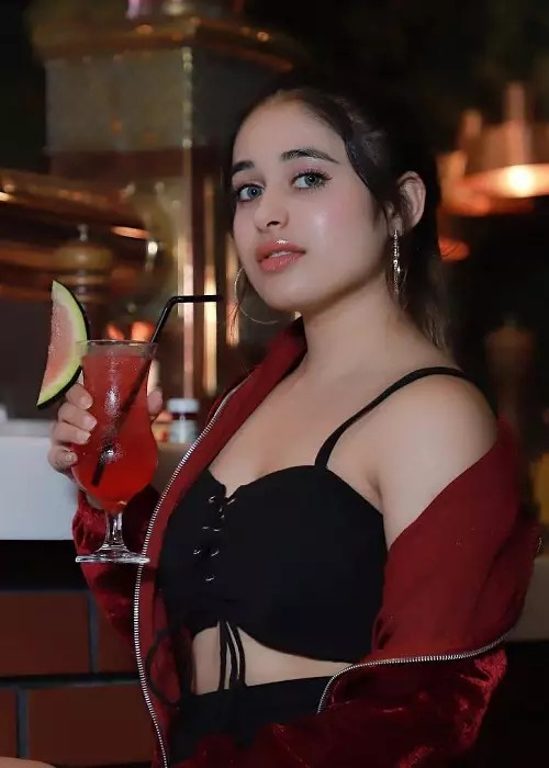 A GIRL 22 YEARS OLD SEXY AND HOT ON BLACK DRESS TAKING JUCE ON HER HAND
